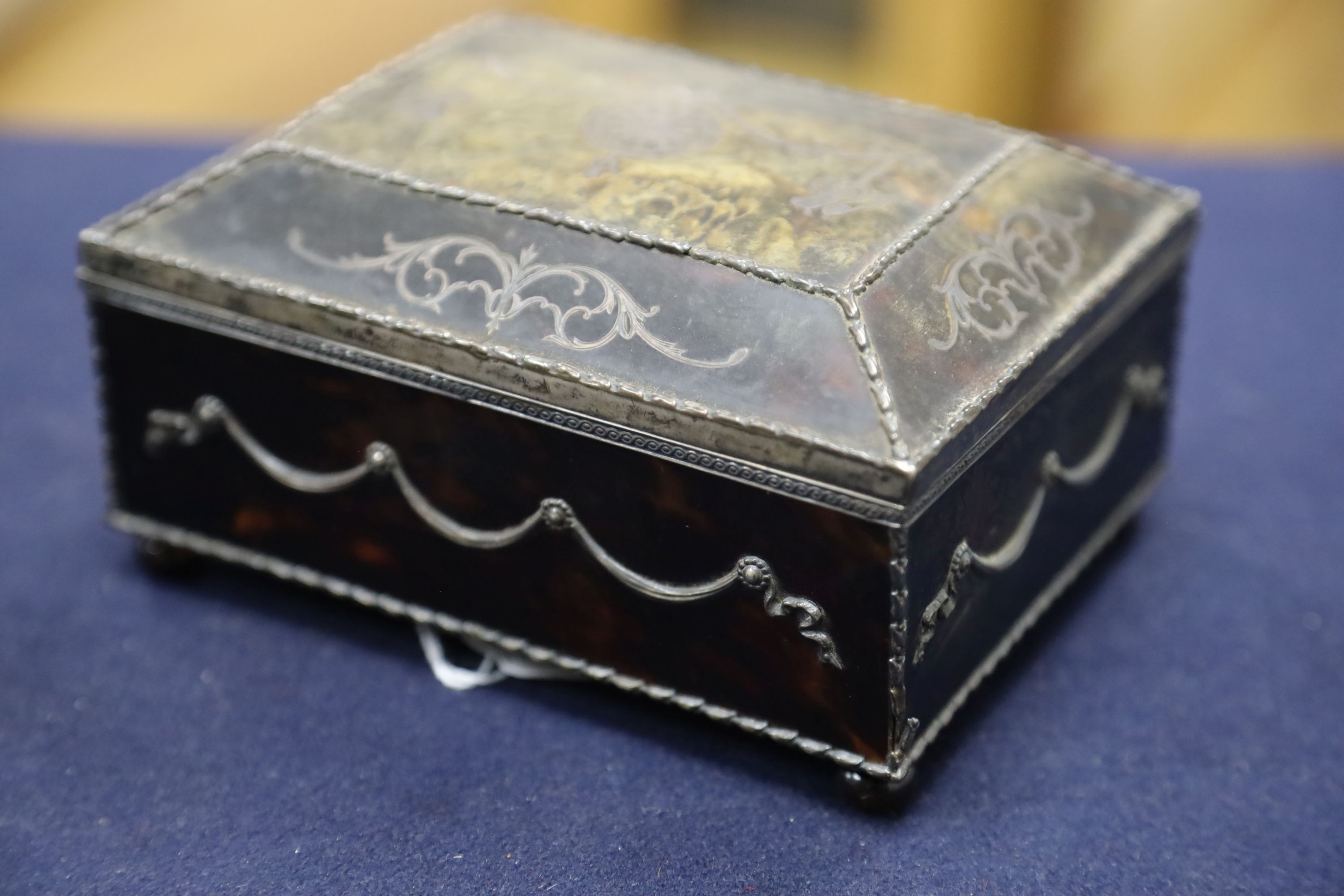 A silver-mounted tortoiseshell pique rectangular trinket box, by William Comyns, raised on four ball feet, London, 1904, width 15cm. 15cm